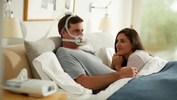 Philips DreamWear Full Face CPAP Mask being worn in bed | Intus Healthcare