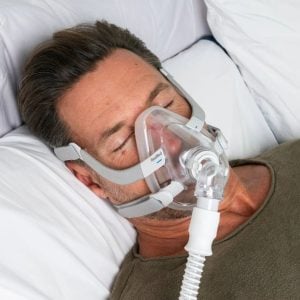 Man wearing ResMed AirFit F40 in bed | Intus Healthcare