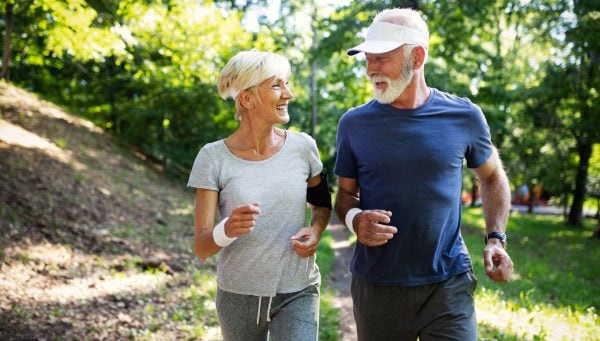 Older couple running in a park