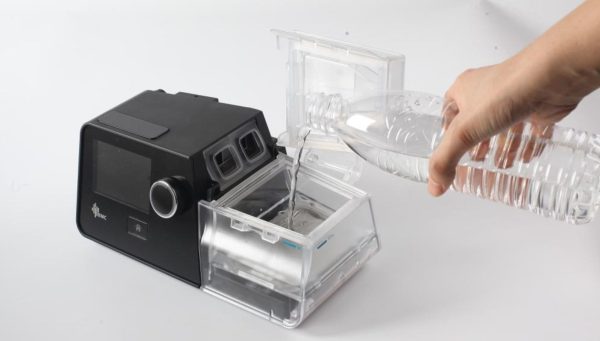 Pouring distilled water into G3 Auto CPAP | Intus Healthcare
