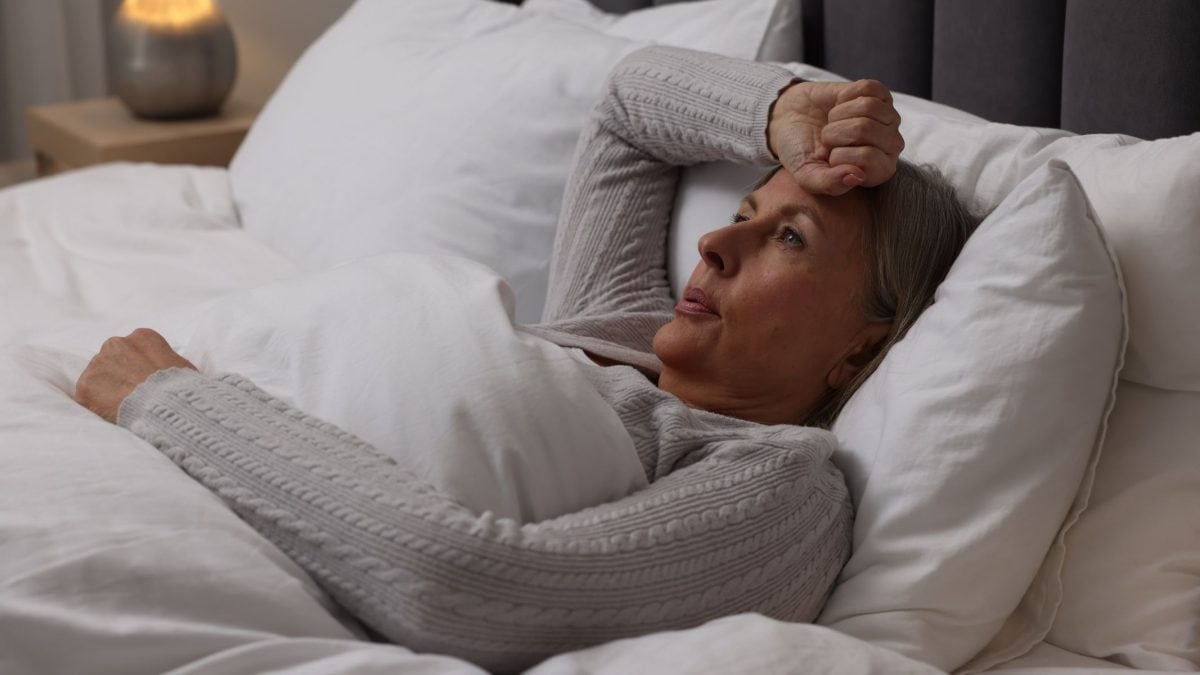 Woman sweating in sleep due to night sweats | Intus Healthcare