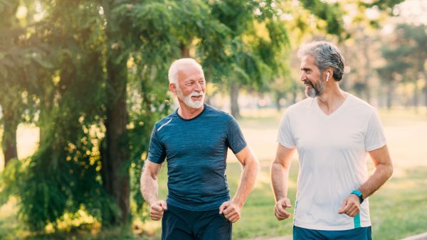 Two older men jogging in the park | Intus Healthcare