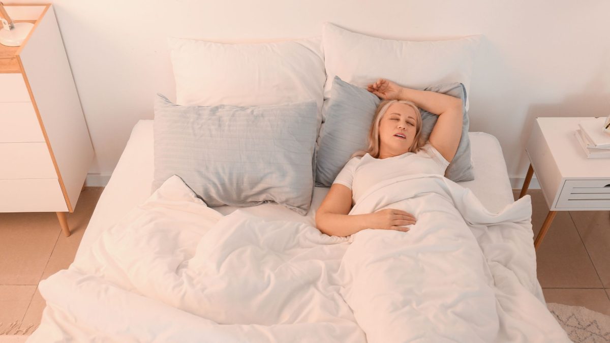 Woman in bed snoring | Intus Healthcare