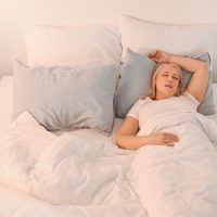Woman in bed snoring | Intus Healthcare