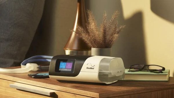 ResMed AirSense 11 Auto CPAP Machine on bedside table with mask | Intus Healthcare